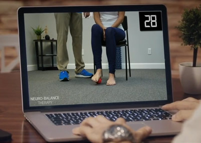 Laptop playing the Neuro-Balance Therapy follow along videos on screen