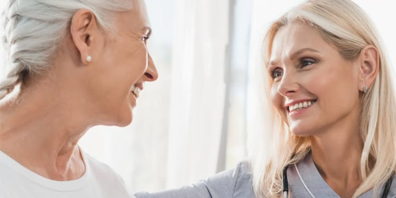 Two women smiling at each other
